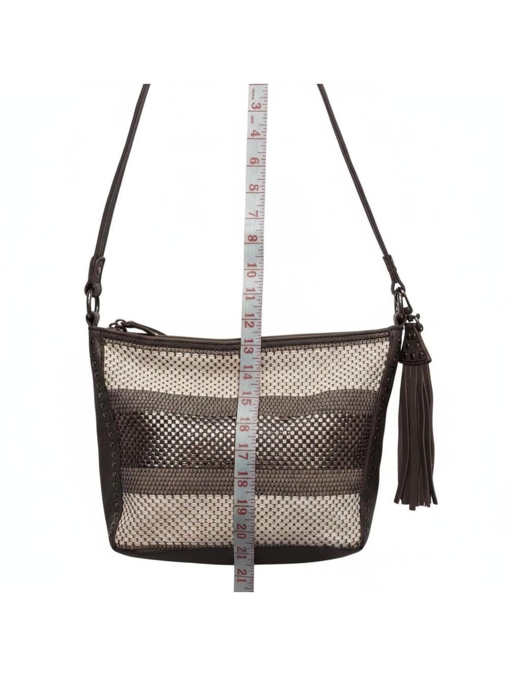 The Sak Genuine Leather Brown Woven Shoulder Bag with Tassel and Metal Rivets